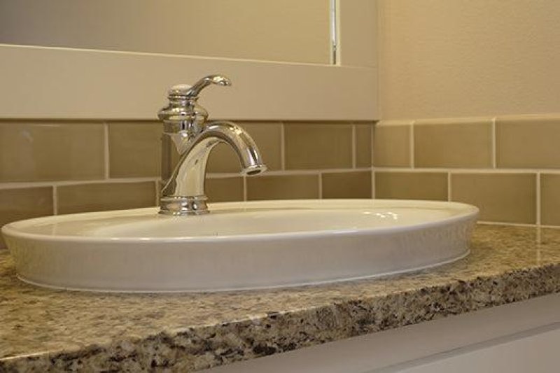 Top counter wash basin design with a raised rim above the countertop